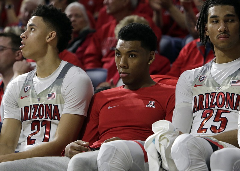 
              FILE - In this Jan. 12, 2017, file photo, Arizona sophomore Allonzo Trier, center, sits on the bench during the first half of an NCAA college basketball game against Arizona State,  in Tucson, Ariz. Trier, who has yet to play this season, admitted Wednesday, Jan. 18, 2017,  that he tested positive for a banned performance-enhancing drug. (AP Photo/Rick Scuteri, File)
            