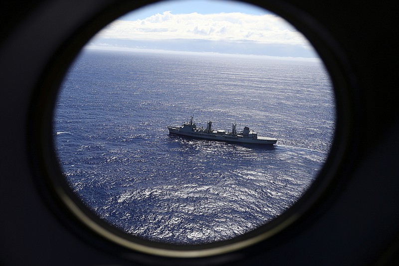 
              FILE - In this March 31, 2014 file photo, HMAS Success scans the southern Indian Ocean, near the coast of Western Australia, as a Royal New Zealand Air Force P3 Orion flies over, while searching for missing Malaysia Airlines Flight MH370. Nearly three years after a Malaysian airliner vanished, it’s still possible, if unlikely, for a plane to disappear. But that’s changing with new satellites that will soon allow flights to be tracked in real time over oceans. (AP Photo/Rob Griffith, File)
            