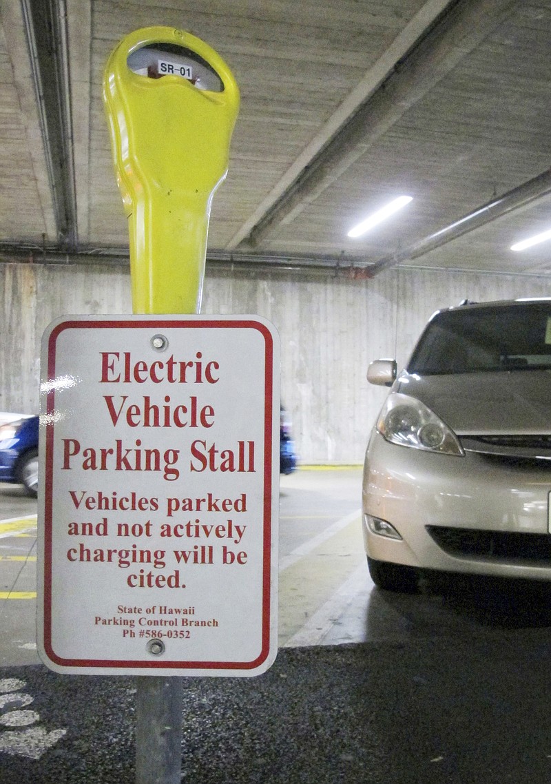 
              An electric vehicle charging station awaits a vehicle in the parking lot at the Hawaii State Legislature on Wednesday, Jan. 18, 2017 in Honolulu. Renewable energy advocates in Hawaii are pushing a bill to urge the transportation sector to get all its energy from renewable sources in 2045. (AP Photo/Cathy Bussewitz)
            