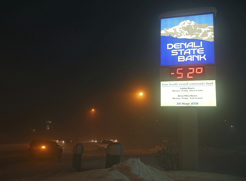 
              The Denali State Bank sign along Chena Pump Road in Fairbanks, Alaska, reflects the frigid temperatures that have enveloped the interior of the state Wednesday, Jan. 18, 2017. (Eric Engman/Fairbanks Daily News-Miner via AP)
            