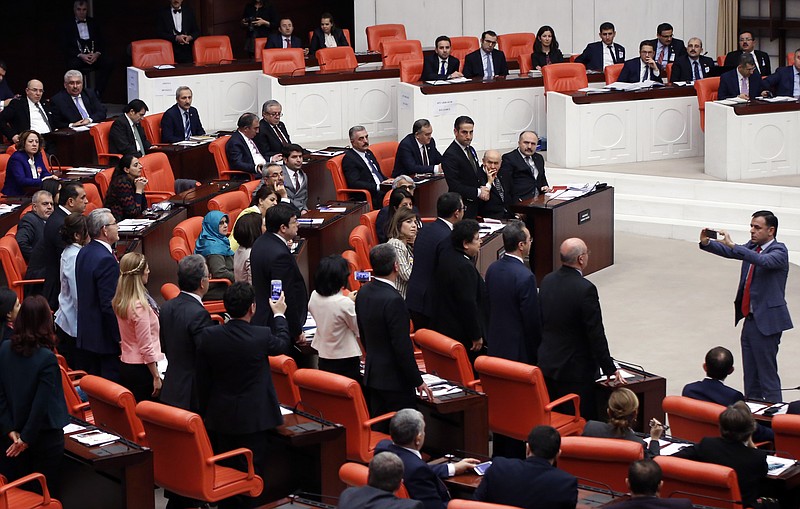 
              Main opposition Republican People's Party, CHP, lawmaker Baris Yarkadas takes a photo of CHP lawmakers as Turkey's parliament debate proposed amendments to the country's constitution that would hand President Recep Tayyip Erdogan's largely ceremonial presidency sweeping executive powers, in Ankara, Turkey, early Thursday, Jan. 19, 2017. Legislators on Wednesday resume their deliberations on the proposed amendments which last week resulted in brawls between ruling and opposition party lawmakers. (AP Photo)
            