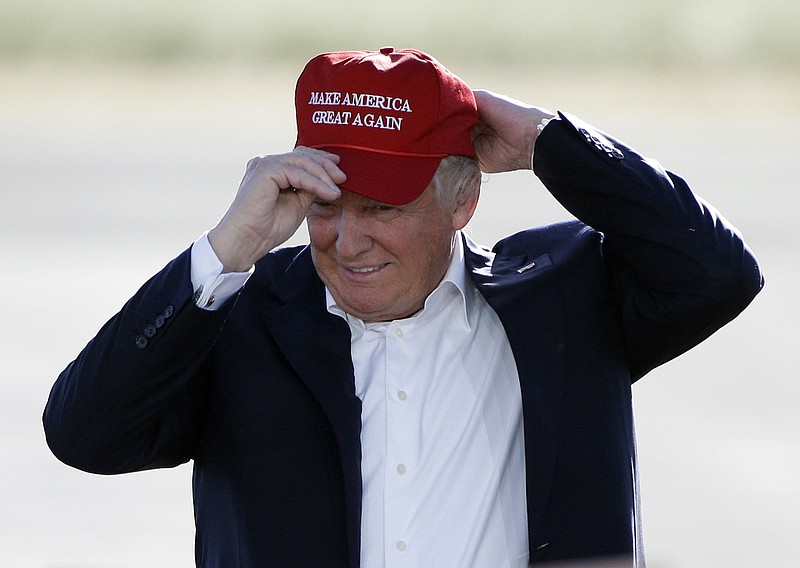 
              FILE - In this June 1, 2016, file photo, Republican presidential candidate Donald Trump wears his "Make America Great Again" hat at a rally in Sacramento, Calif. Donald Trump enters the White House on Jan. 20 just as he entered the race for president: defiant, unfiltered, unbound by tradition and utterly confident in his chosen course. In the 10 weeks since his surprise election as the nation’s 45th president, Trump has violated decades of established diplomatic protocol, sent shockwaves through business boardrooms, tested long-standing ethics rules and continued his combative style of replying to any slight with a personal attack _ on Twitter and in person. (AP Photo/Jae C. Hong, File)
            