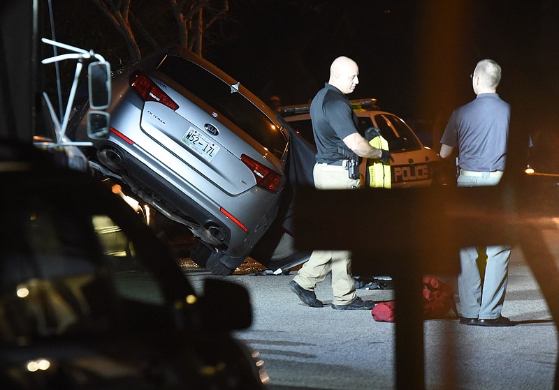Police investiage after a shooting and crash left two dead and a car piled on another vehicle on East 12th Street in Chattanooga Jan. 20.