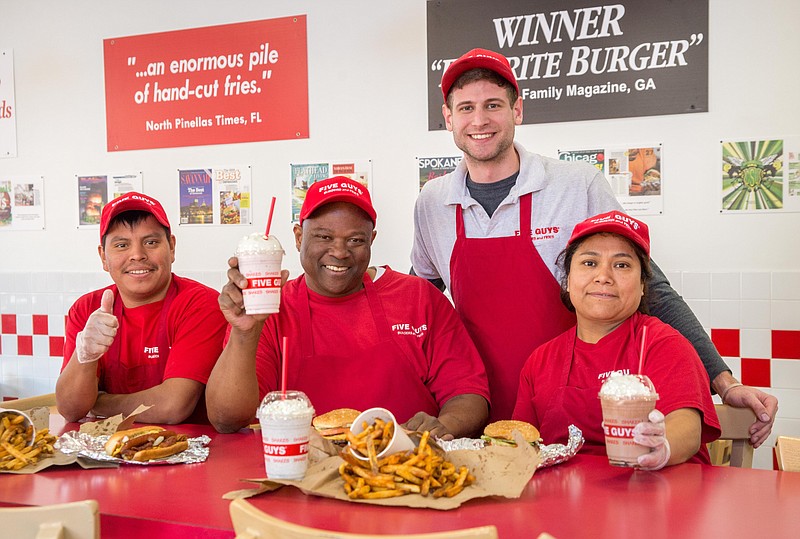 Alfonso Tomas Perez, Garry Mitchell, Brody Laws and Linda Garcia of Five Guys want to serve you.