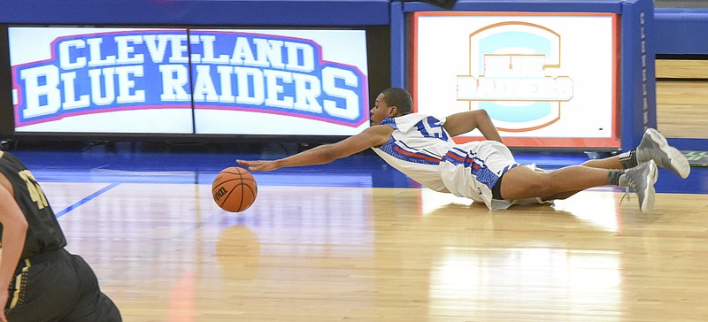 Cleveland's Dionte Ware (15) stretches to save a loose ball early in first half action against cross-town rival Bradley Central Friday night.