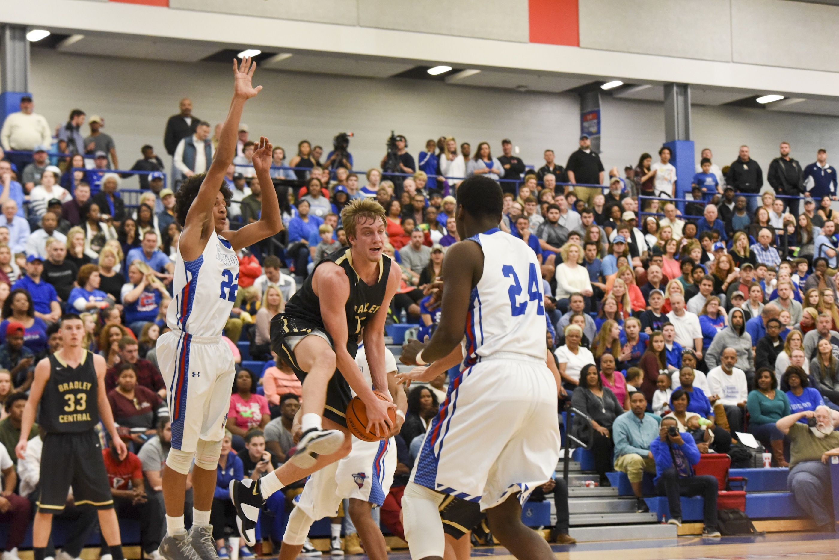 Bradley Central's Cole Copeland, center, pulls down a rebound between Cleveland's Deontae Davis (22) and Tave Cobb (24) in first half action at Cleveland Friday night.