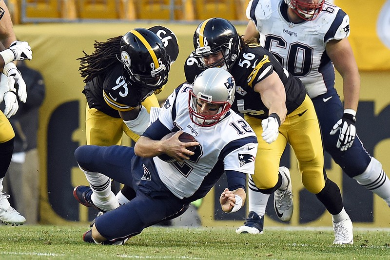 
              FILE - In this Oct. 23, 2016, file photo, New England Patriots quarterback Tom Brady (12) is sacked by Pittsburgh Steelers outside linebackers Jarvis Jones (95) and Anthony Chickillo (56) during the second half of an NFL football game in Pittsburgh. The Steelers haven’t been great at pressuring quarterbacks recently, or had much historical success against Brady.  But Brady will face a much healthier Steelers' pass rush in the AFC Championship on Sunday, than he did in Week 7’s win. Pittsburgh linebacker Ryan Shazier was returning from a knee injury; James Harrison played only 42 percent of the snaps and Bud Dupree was on injured reserve. (AP Photo/Don Wright, File)
            