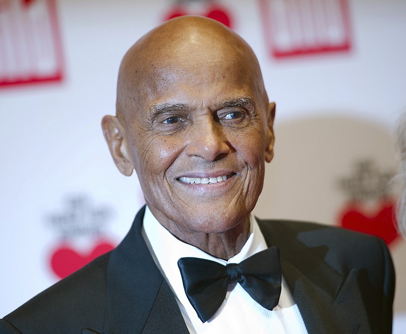 
              FILE - In this Dec. 6, 2014 file photo, Harry Belafonte arrives at the charity gala Ein Herz fuer Kinder (A heart for children) in Berlin. Belafonte will celebrate his 90th with a new musical project featuring a children’s choir singing one of his famous songs, ‘Island In the Sun,’ an an attempt to promote racial harmony.  (AP Photo/Steffi Loos, File)
            