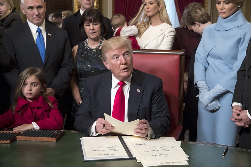 President Donald Trump is joined by the Congressional leadership and his family as he formally signs his cabinet nominations into law, Friday, Jan. 20, 2017, in the President's Room of the Senate on Capitol Hill in Washington. From left are, his granddaughter Arabella Rose, Vice President Mike Pence and his wife Karen Pence, Ivanka Trump, and the president's wife, Melania Trump. (AP Photo/J. Scott Applewhite, Pool)