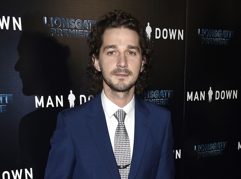 
              FILE - This Nov. 30, 2016 file photo shows Shia LaBeouf at the premiere of "Man Down" in Los Angeles. LaBeouf led a group of teenagers with the chant: “He will not divide us.” Looking into a camera placed on a wall outside the Museum of the Moving Image in New York, a diverse group of teenagers chanted the words on the day Donald Trump was named president in Washington, D.C. (Photo by Chris Pizzello/Invision/AP, File)
            