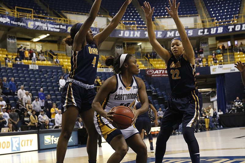 UTC guard Queen Alford, center, tries to find room between UNCG forward Mangela Ngandjui, left, and India Timpton during the Mocs' home basketball game against UNCG at McKenzie Arena on Saturday, Jan. 21, 2017, in Chattanooga, Tenn. 