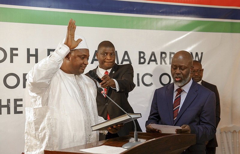 
              Adama Barrow, left, is sworn in as President of Gambia at Gambia's embassy in Dakar Senegal, Thursday, Jan 19, 2017. A new Gambian president has been sworn into office in neighboring Senegal, while Gambia's defeated longtime ruler refuses to step down from power, deepening a political crisis in the tiny West African country. (AP Photo)
            