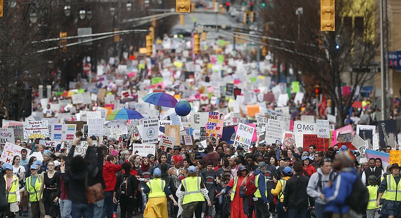 
              Demonstrators march Saturday, Jan. 21, 2017, in Atlanta. Thousands of people marched through Atlanta one day after President Donald Trump's inauguration. (AP Photo/John Bazemore)
            