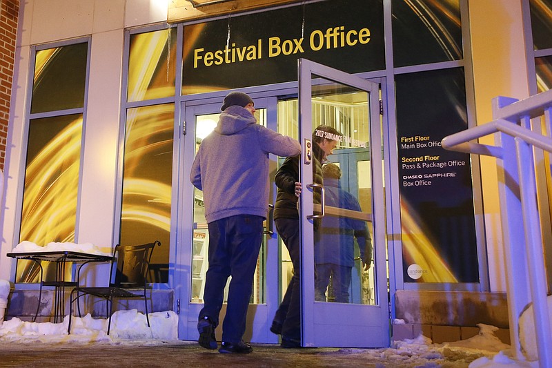 
              People enter a door leading to the Festival Box Office during the 2017 Sundance Film Festival on Saturday, Jan. 21, 2017, in Park City, Utah. Representatives for the Sundance Film Festival say that their network systems were subject to a cyberattack that caused its box offices to shut down briefly Saturday afternoon. (Photo by Danny Moloshok/Invision/AP)
            