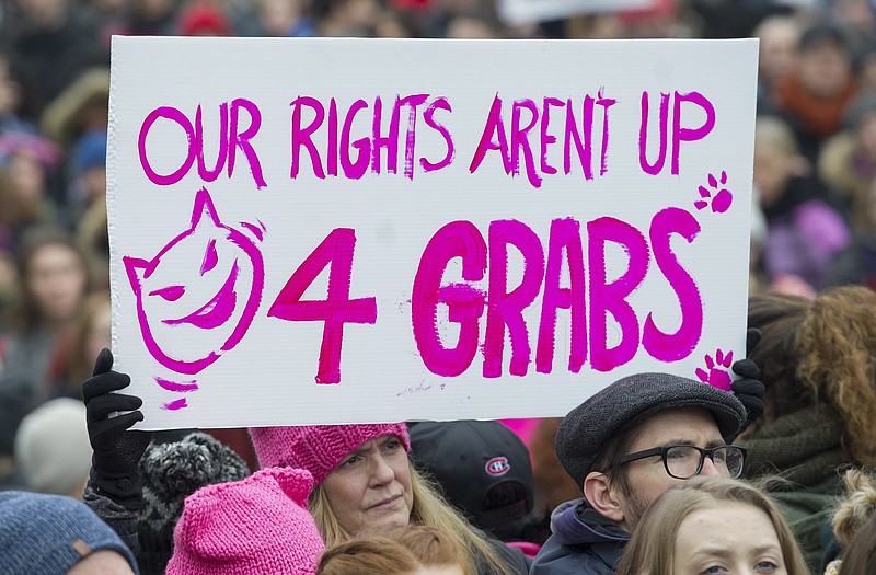 A woman holds up a sign during a demonstration to protest the inauguration of U.S. President Donald Trump in Montreal, Saturday, Jan. 21, 2017. Protests are being held across Canada today in support of the Women's March on Washington. Organizers say 30 events in all have been organized across Canada, including Ottawa, Toronto, Montreal and Vancouver. (Graham Hughes/The Canadian Press via AP)

