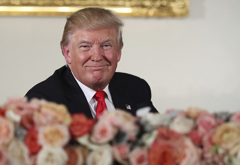 President Donald Trump smiles during the inaugural luncheon at the Statuary Hall in the Capitol Friday. (AP Photo/Manuel Balce Ceneta)