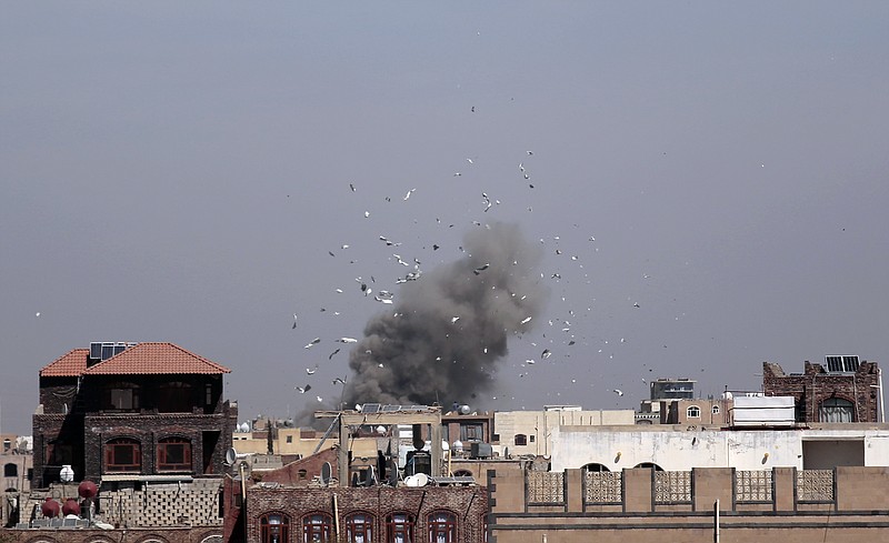 
              Debris and smoke rise after a Saudi-led airstrike hit an army base, in Sanaa, Yemen, Sunday, Jan. 22, 2017. (AP Photo/Hani Mohammed)
            