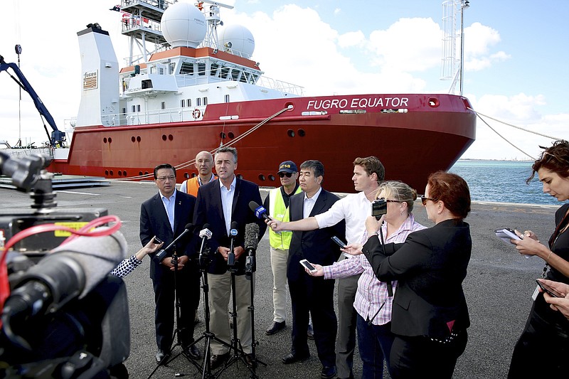 
              Australian Federal Infrastructure and Transport Minister Darren Chester, third left, holds a press conference, Monday, Jan. 23, 2017, in Perth, Australia, with Malaysian Transport Minister Liow Tiong Lai, left, and other officials in front of the search ship Fugro Equator, one of the vessels involved in the MH370 search. Transport officials from Australia, Malaysia and China met the crew of Fugro Equator, who were ordered to return last week after the countries officially suspended the nearly three-year search for the plane in the Indian Ocean. (Richard Wainwright/AAP Image via AP)
            