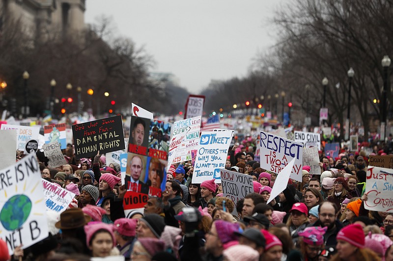 
              Protesters move along Constitution Avenue at the Women's March on Washington during the first full day of Donald Trump's presidency, Saturday, Jan. 21, 2017 in Washington.  (AP Photo/John Minchillo)
            