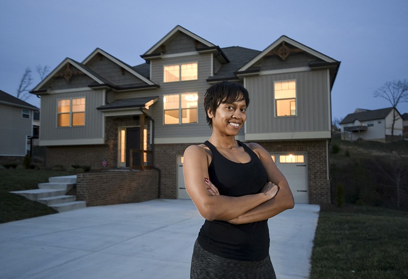 Tabitha Russell, 32, a millennial, stands in front of the new home she purchased last week in Ooltewah.