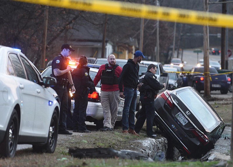 Officers investigate Monday, Jan. 23, 2017, after a police chase ended when the suspect vehicle crashed on Monroe Street just off of Wilcox Boulevard.