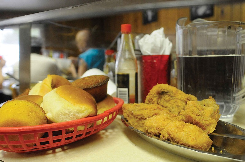 Fried chicken and bread are among many items that grace the table at Bea's Restaurant. The restaurant offered meals for a dollar to celebrate its 60th anniversary.