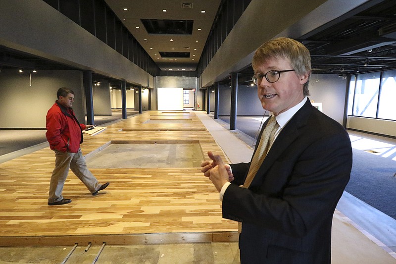 In this file photo Vince Butler, left, examines the space as Daryl Black, right, leads a tour of the new Chattanooga History Center on Friday, January 15, 2015.