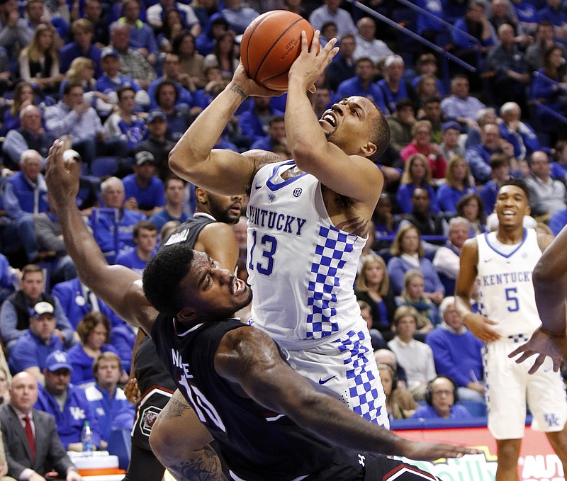 Kentucky's Isaiah Briscoe, top, collides with South Carolina's Duane Notice during the first half of an NCAA college basketball game, Saturday, Jan. 21, 2017, in Lexington, Ky. (AP Photo/James Crisp)