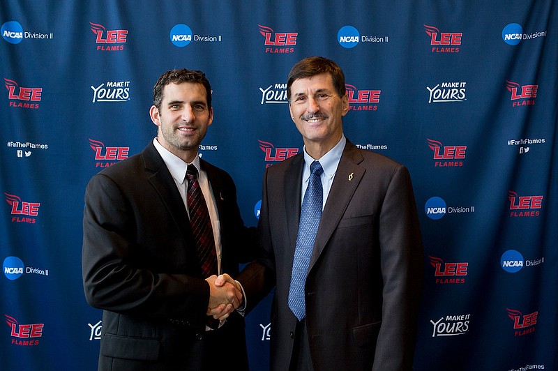 Lee University president Dr. Paul Conn, right, welcomes Derek Potteiger as the school's men's soccer coach. (Lee University photo)