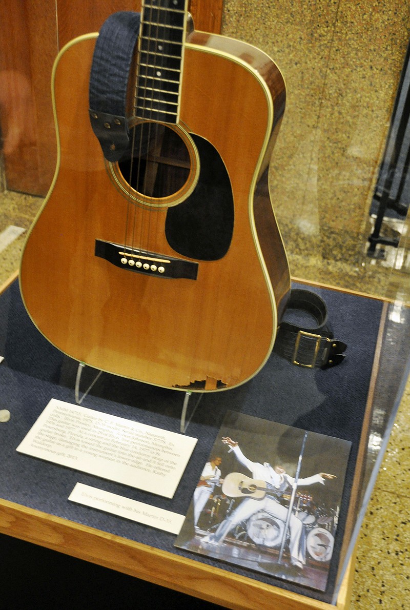 
              FILE - This April 22, 2013, file photo, shows the slightly smashed acoustic guitar played by Elvis Presley during the final tour before his death in 1977 on display at the National Music Museum in Vermillion, S.D. A federal judge has ruled Monday, Jan. 23, 2017, that the South Dakota museum is the legal owner of the guitar played by Elvis Presley. (AP Photo/Dirk Lammers, File)
            