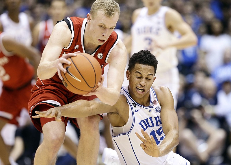 
              N.C. State's Maverick Rowan, left, and Duke's Frank Jackson (15) chase a loose ball during the first half of an NCAA college basketball game in Durham, N.C., Monday, Jan. 23, 2017. (AP Photo/Gerry Broome)
            