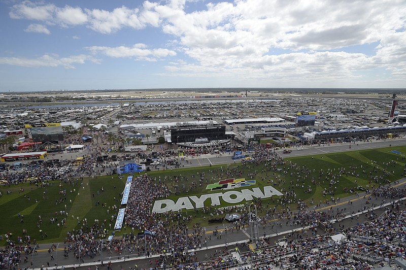 
              FILE - This Feb. 21, 2016 file photo shows fans gathering on the grass in front of the grandstands of Daytona International Speedway before the NASCAR Daytona 500 Sprint Cup series auto race in Daytona Beach, Fla. NASCAR is dramatically changing its format for the upcoming season, cutting every race into stages that reward points in hopes of making every lap matter. The overhaul announced Monday, Jan. 23, 2017 assigns three stages to every race. (AP Photo/Phelan M. Ebenhack)
            