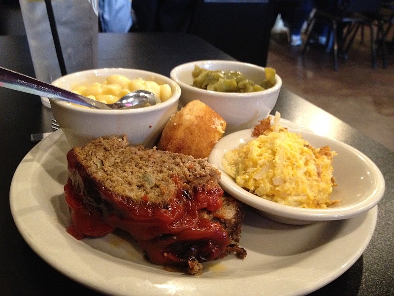 Meatloaf is served with sides of macaroni and cheese, green beans and hashbrown casserole, clockwise from left, along with a cornbread muffin, at Home Plate Grill in Ringgold, Ga.