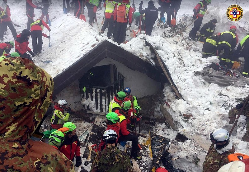 
              Italian Mountain Rescue Corps "Corpo Nazionale Soccorso Alpino e Speleologico" Soccorso Alpino volunteers and rescuers work in the area of the avalanche-struck Hotel Rigopiano, near Farindola, central Italy, Sunday, Jan. 22, 2017. Rescue crews are considering whether to start using heavy equipment to speed up the search for 23 people still buried under the ruins of a central Italy hotel crushed by an avalanche. (Corpo Nazionale Soccorso Alpino e Speleologico/ANSA via AP)
            