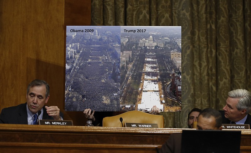 
              Senate Budget Committee members Sen. Jeff Merkley, D-Ore., left, and Sen. Sheldon Whitehouse, D-R.I., flank a large photograph held up that shows and compares Inauguration crowd sizes in 2009 and 2017 as Merkley questions Budget Director-designate Rep. Mick Mulvaney, R-S.C., on Capitol Hill in Washington, Tuesday, Jan. 24, 2017, at Mulvaney's confirmation hearing before the committee. (AP Photo/Carolyn Kaster)
            