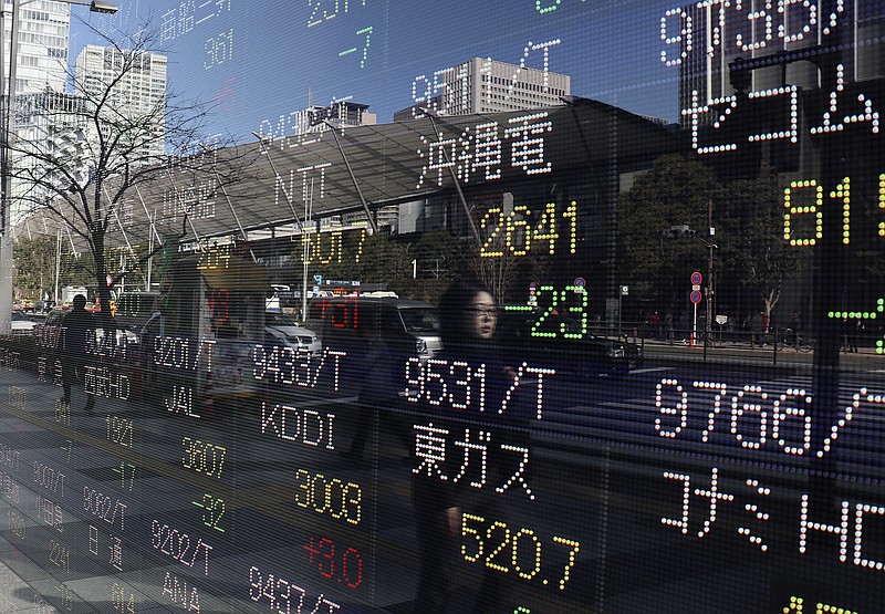 
              A woman is reflected on an electronic stock indicator of a securities firm in Tokyo, Tuesday, Jan. 24, 2017. Asian shares were mixed Tuesday as uncertainty mounted over U.S. President Donald Trump's trade and regulatory policies. (AP Photo/Shizuo Kambayashi)
            