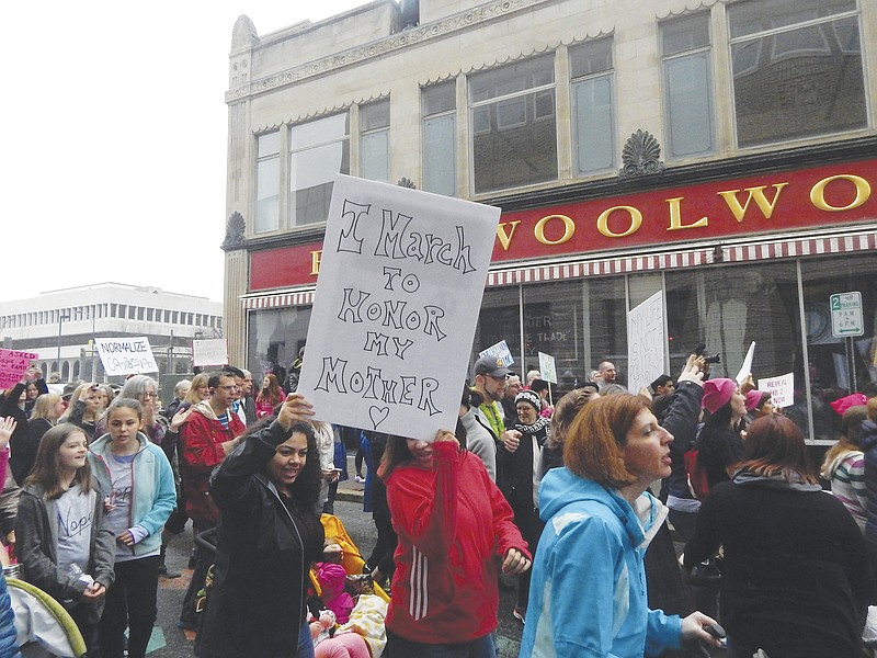 
              Protestors march past the Civil Rights Museum during the Triad NC Women's March in Greensboro, N.C., Saturday, Jan. 22, 2017.  (Cinde Ingram/The High Point Enterprise via AP)
            