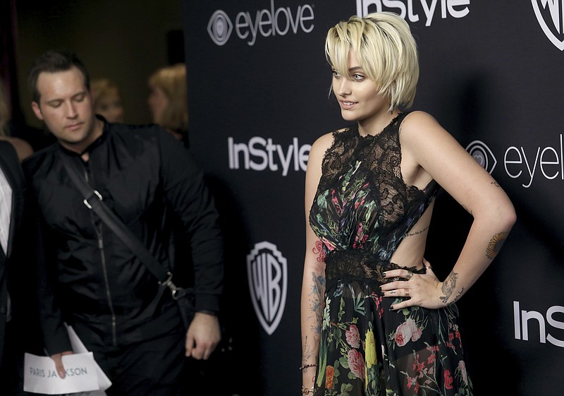 
              FILE - In this Jan. 8, 2017, file photo, Paris Jackson arrives at the InStyle and Warner Bros. Golden Globes afterparty at the Beverly Hilton Hotel in Beverly Hills, Calif. Jackson said in a Rolling Stone interview published online on Jan. 24, 2017, that she tried to kill herself “multiple times” in the years after her father’s death. (Photo by Matt Sayles/Invision/AP, File)
            