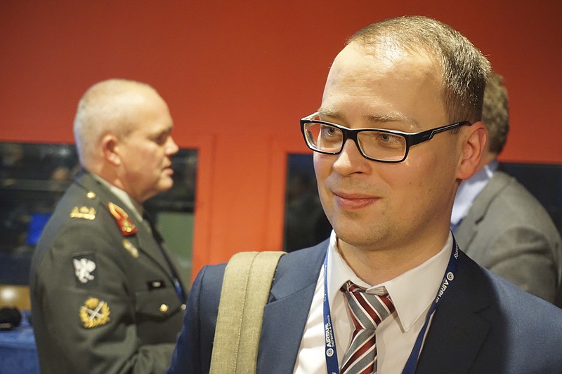 
              Estonian defense official Erki Kodar chats with a conference goer as part of a Cyber Security conference held in Lille, northern France, Tuesday, Jan. 24, 2017. Estonia is experimenting with the idea of cyberconscription, giving draftees with tech skills the chance to step into roles defending the military's electronic infrastructure. (AP Photo/Raphael Satter)
            