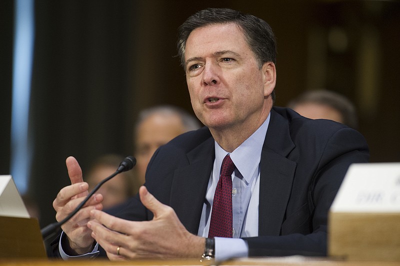 
              FILE - In this Jan. 10, 2017 file photo, FBI Director James Comey testifies on Capitol Hill in Washington. Comey is staying in his job. A Justice Department memo lists him among officials remaining in their positions.  (AP Photo/Cliff Owen, File)
            