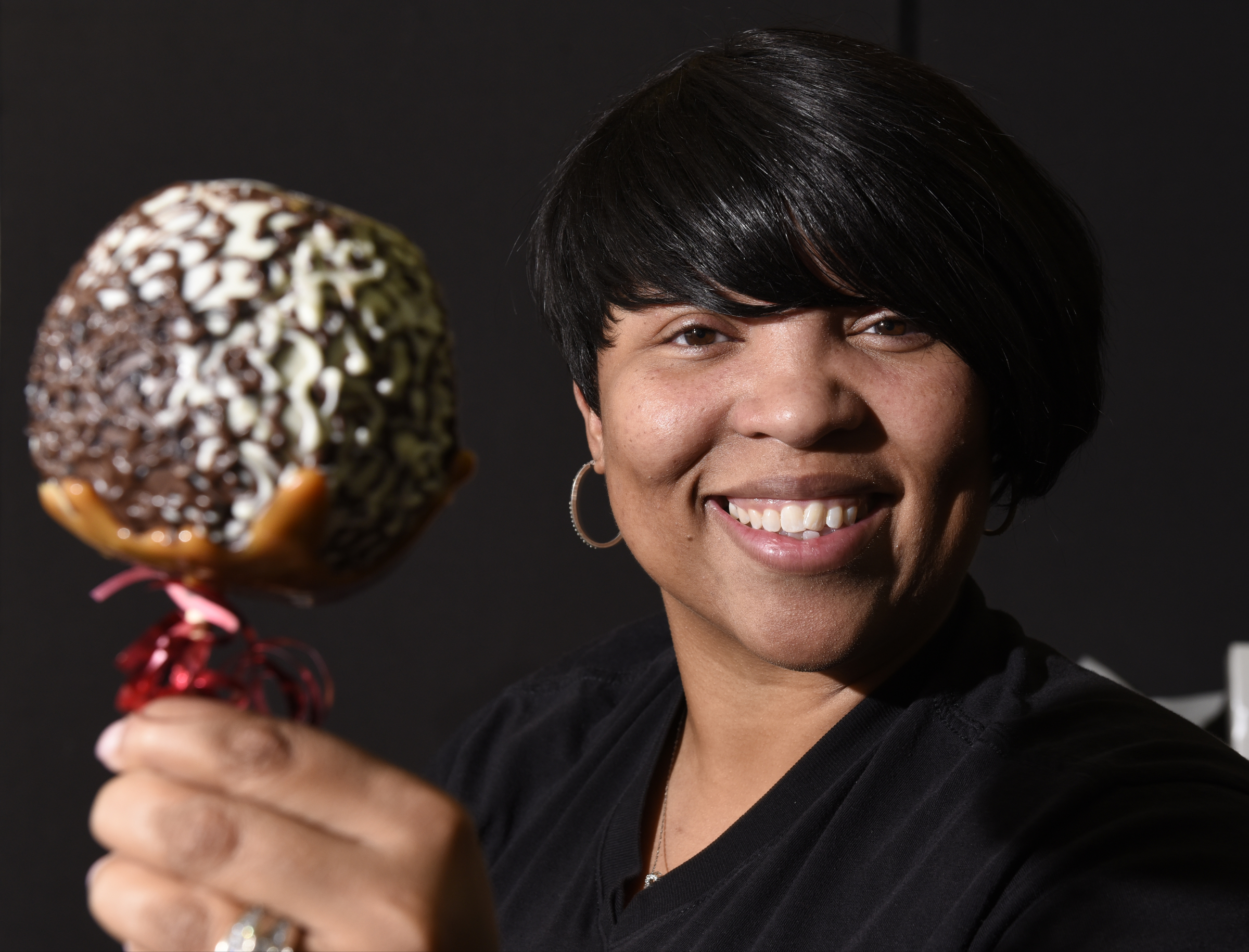 Antonia Poland, who founded Dipped Fresh along with Cynthia Wood, is photographed with a chocolate caramel apple, one of the delicacies made by her company, on Wednesday, Jan. 28, 2016, in Chattanooga, Tenn.,