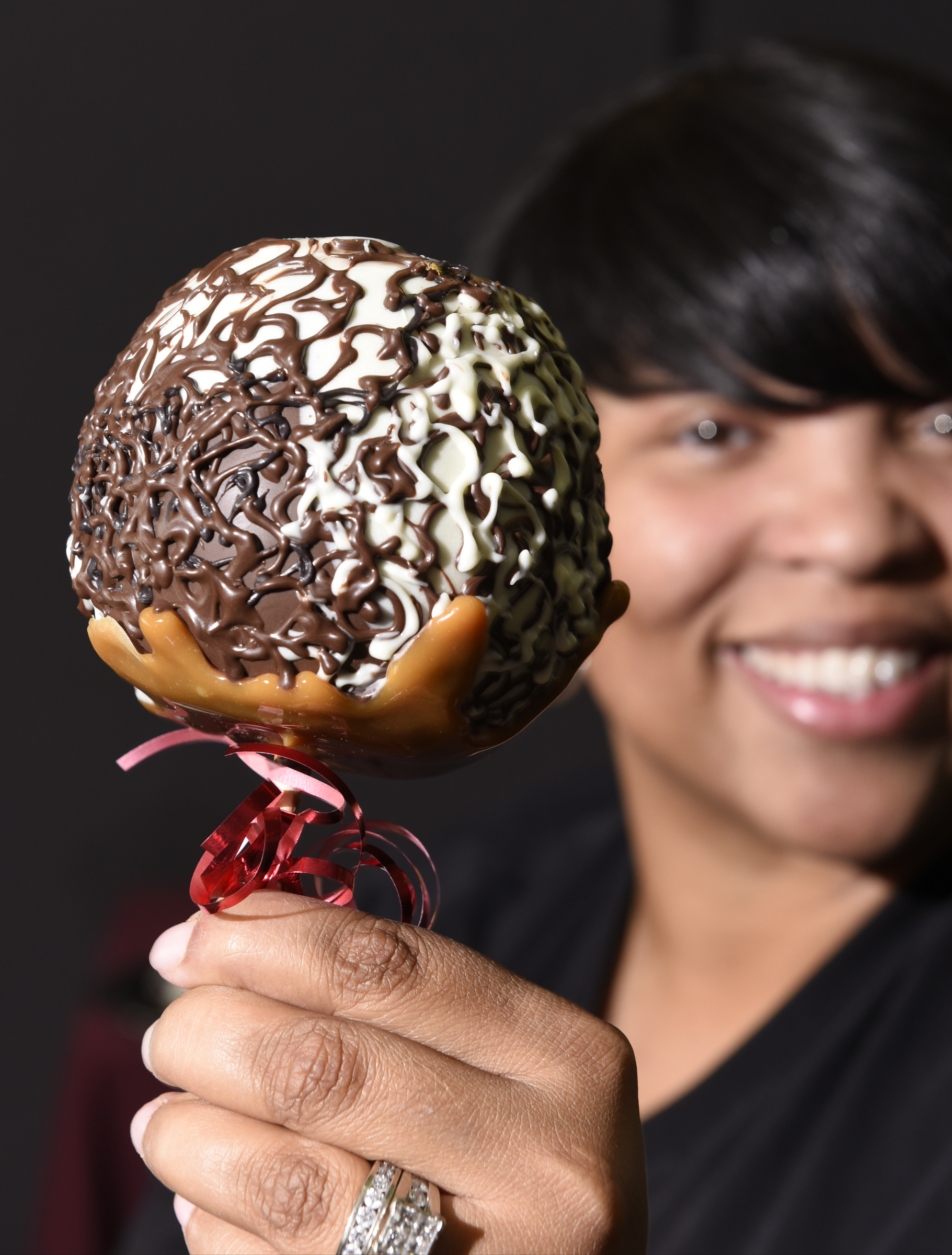 Antonia Poland, who founded Dipped Fresh along with Cynthia Wood, is photographed with a chocolate caramel apple, one of the delicacies made by her company, on Wednesday, Jan. 28, 2016, in Chattanooga, Tenn.,