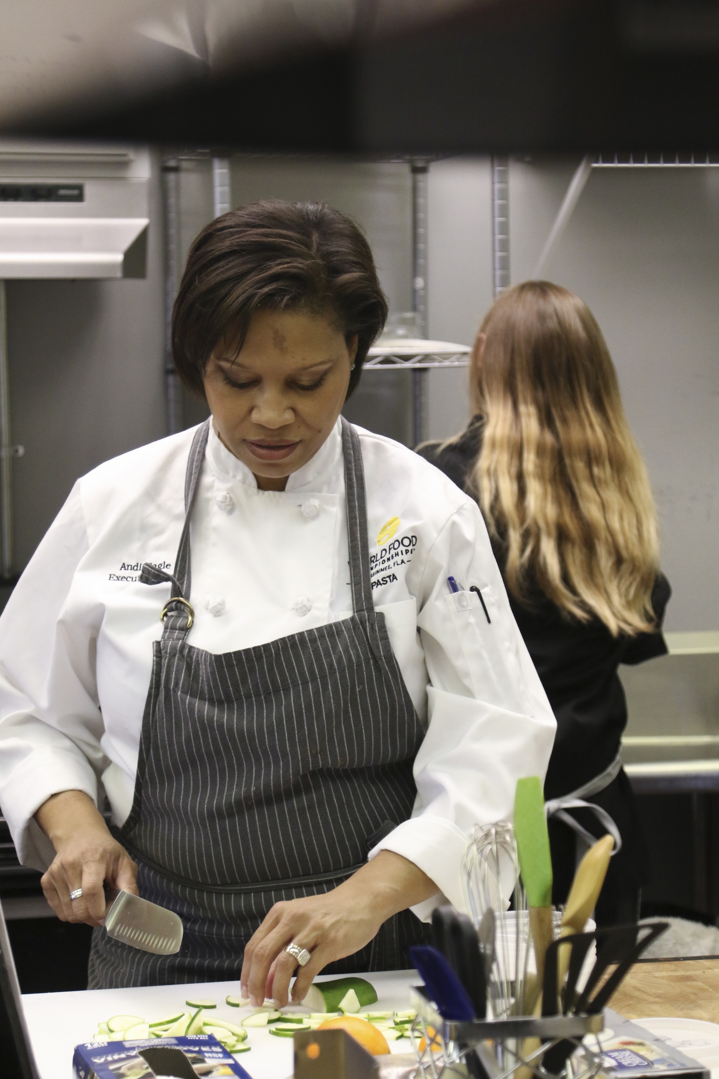 Staff Photo by Dan Henry / The Chattanooga Times Free Press- 1/13/17. Andi Cagle, executive chef and owner of Kozy Cooking, slices cucumbers while preparing for a catering event in Atlanta.