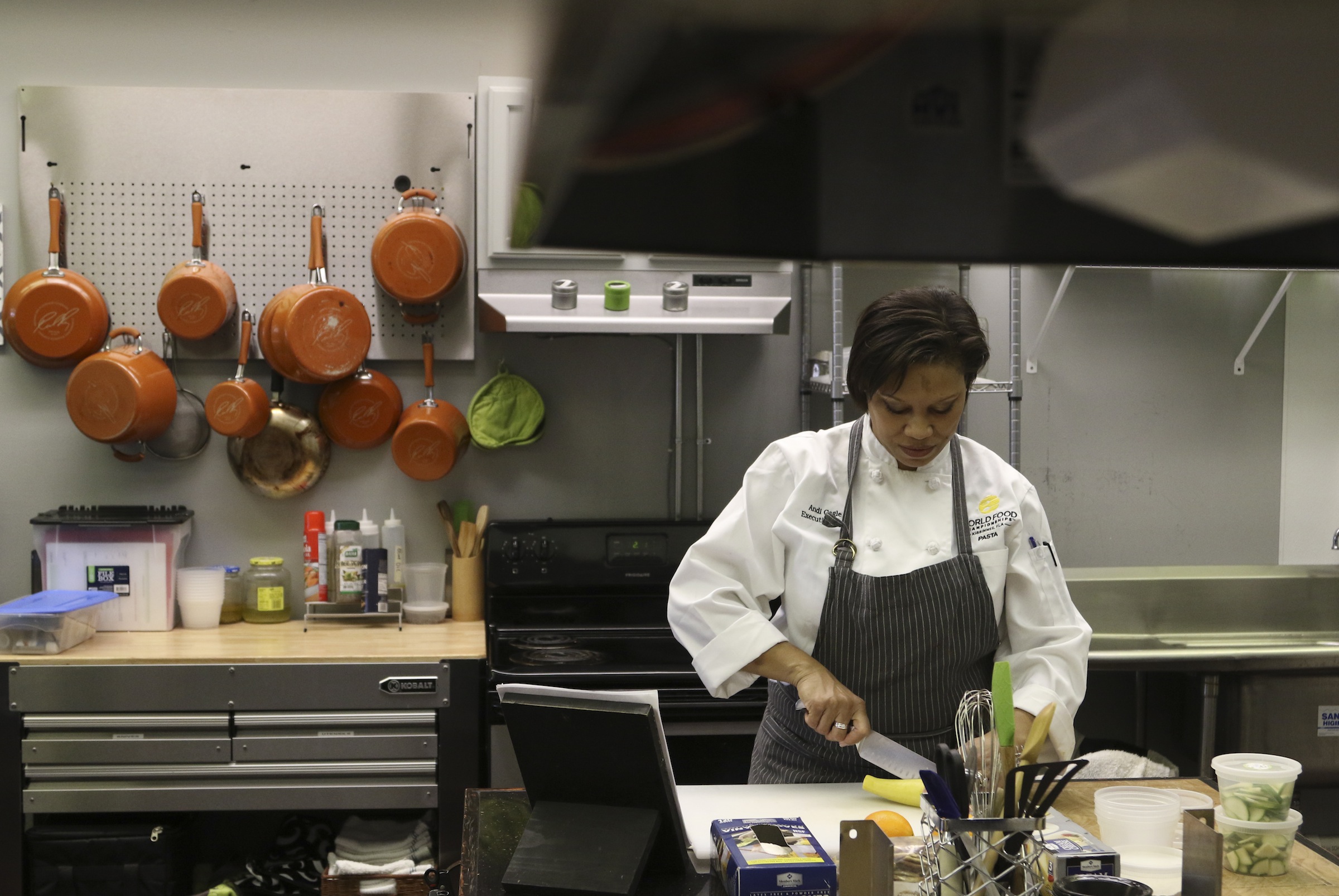 Staff Photo by Dan Henry / The Chattanooga Times Free Press- 1/13/17. Andi Cagle, executive chef and owner of Kozy Cooking, slices cucumbers while preparing for a catering event in Atlanta.