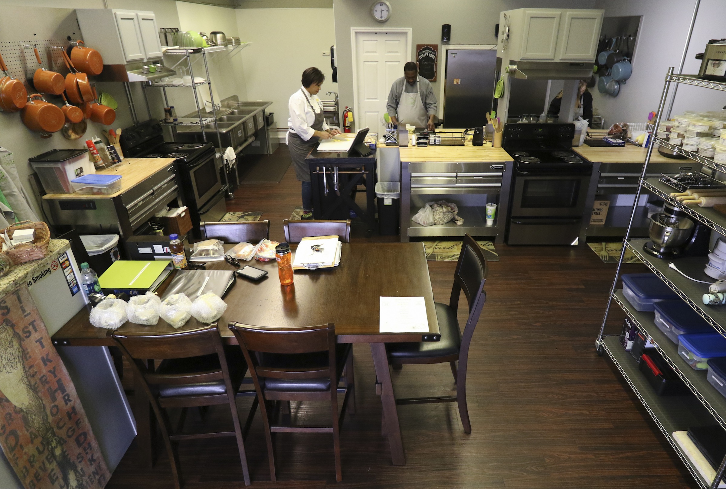 Staff Photo by Dan Henry / The Chattanooga Times Free Press- 1/13/17. Andi Cagle, executive chef and owner of Kozy Cooking, speaks to sous chef Cornelius McClain and prep chef Renee Nichols, from left, while preparing for a catering event in Atlanta.