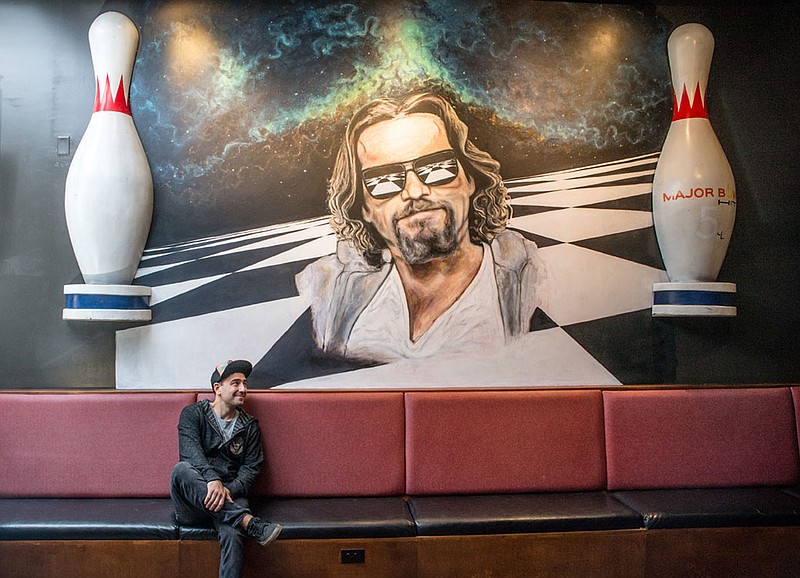 Ryan "Coop" Carl painted the mural from The Big Lebowski in the Boom Room at the downtown location of Mellow Mushroom. (Photo by Mark Gilliland)