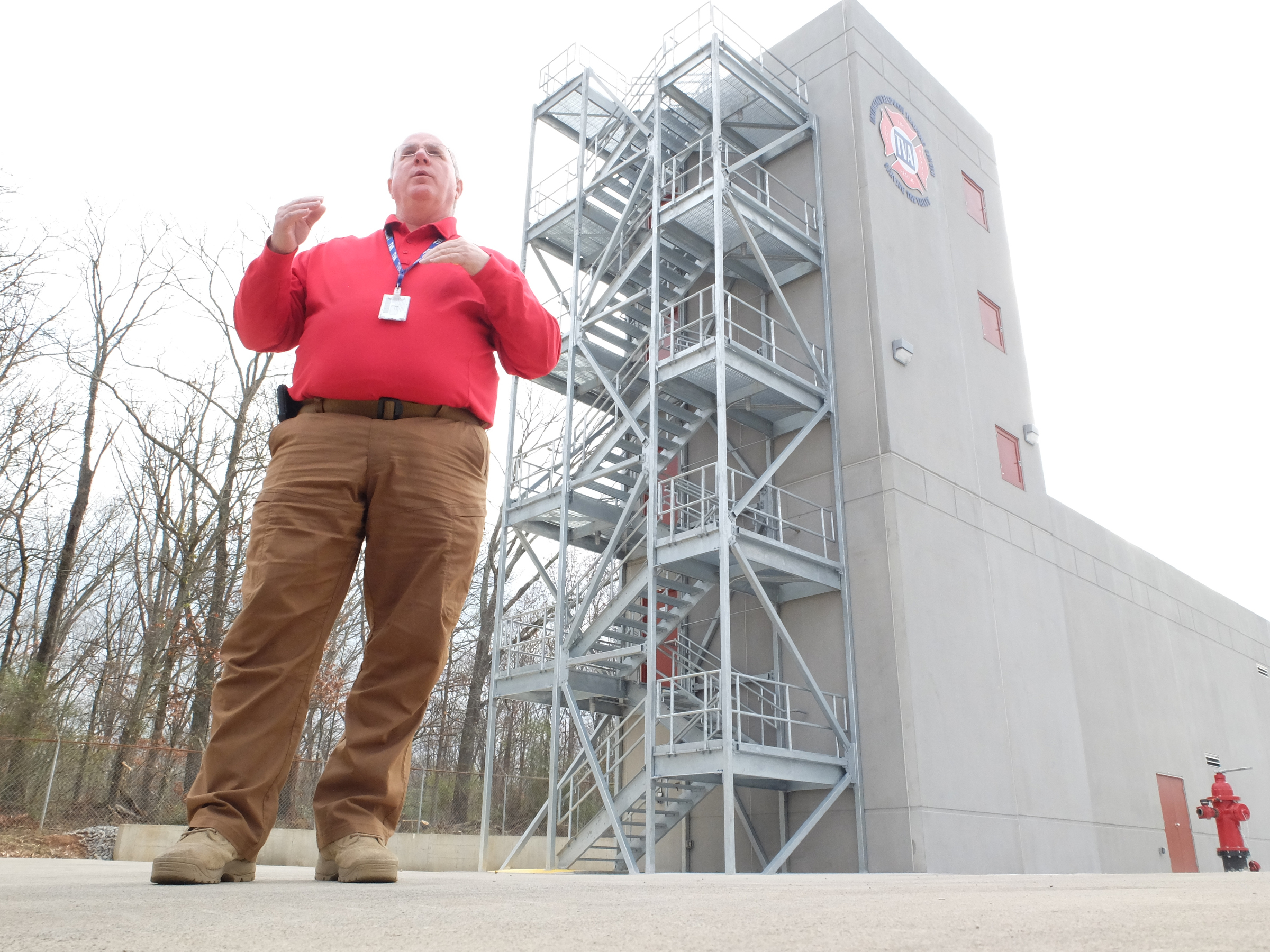 Phillip Johnson, manager of emergency response training at the Tennessee Valley Authority's Emergency Response Training Center, explains the procedures students are required to accomplish in fire fighting outside the training building in Marion County.