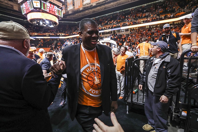 Former Tennessee standout Bernard King greets a fan Tuesday night at Thompson-Boling Arena, where the Vols upset No. 4 Kentucky 82-80.