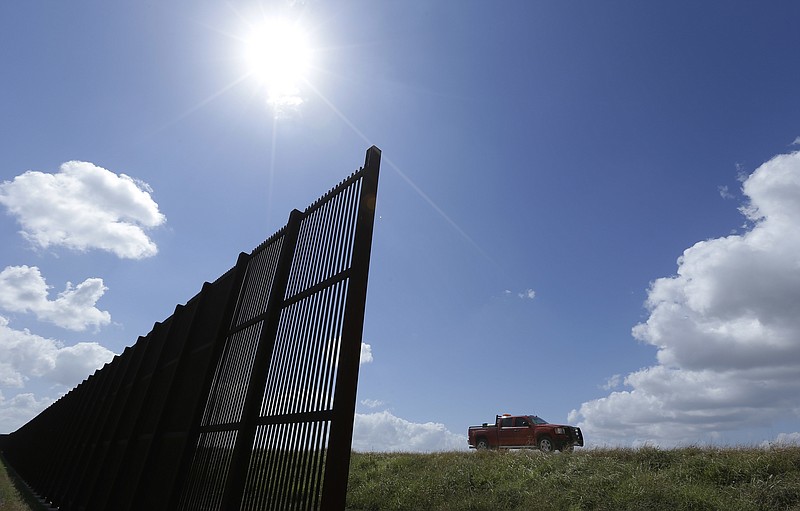 
              FILE - In this Sept. 6, 2012, file photo, cotton farmer Teofilo "Junior" Flores drives his truck along the U.S.-Mexico border fence that passes through his property in Brownsville, Texas. President Donald Trump’s vow to accelerate construction of a “contiguous, physical wall” along the Mexican border is slamming into a Washington reality _ who’s going to pay for it and how? (AP Photo/Eric Gay, File)
            