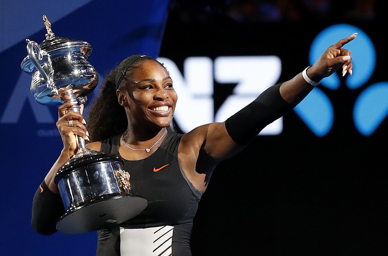 United States' Serena Williams holds her trophy after defeating her sister Venus during the women's singles final at the Australian Open tennis championships in Melbourne, Australia, Saturday, Jan. 28, 2017. (AP Photo/Dita Alangkara)